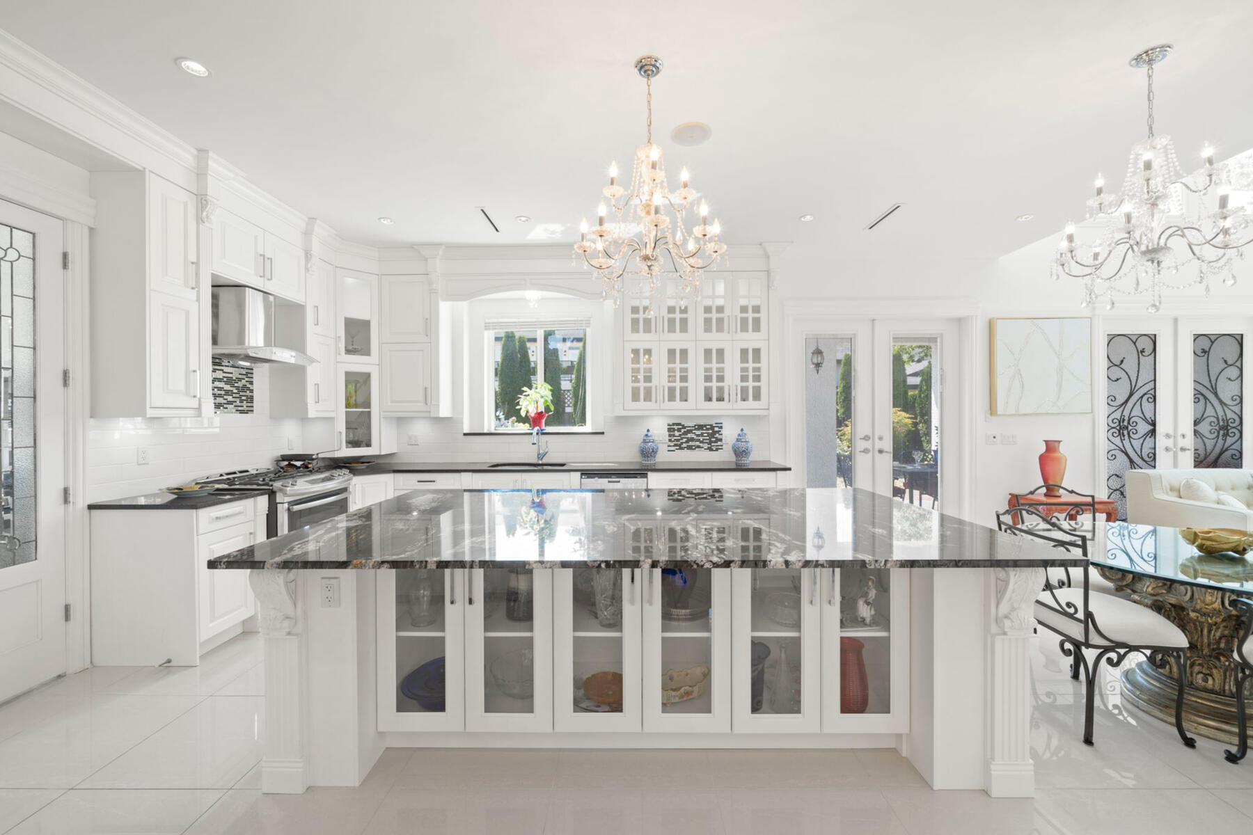 Kitchen. At the heart of the home, a 10-foot Brazilian granite island creates a natural gathering place for family and friends—with generous storage and space for everything from quiet mornings to lively evenings.
