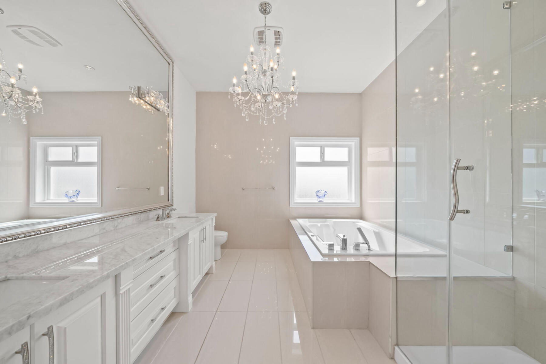 A quieter kind of luxury. The spa-inspired ensuite pairs double vanities with a rain shower and jetted tub—creating a private place to reset at the beginning and end of each day.